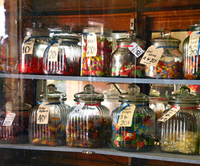 Candy lolly jars of glass and price tages look sweet and traditional in small country town shop.