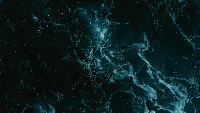 aerial drone footage top looking down of surf waves rolling over a reef with white water break