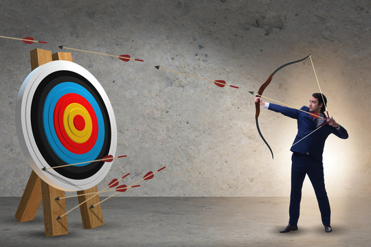 Businessman aiming arrow with bow