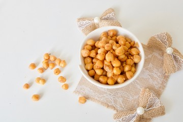 Tasty crispy chickpea in the white plate on the white table