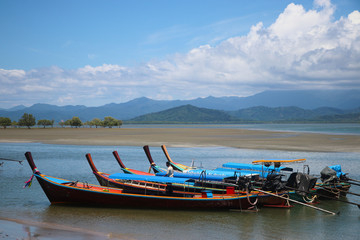 Wooden boats on beach landscape with sky and mountian background