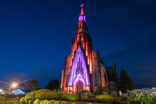 Photo of the Cathedral of Cinnamon and its beautiful garden on a night of starry sky.