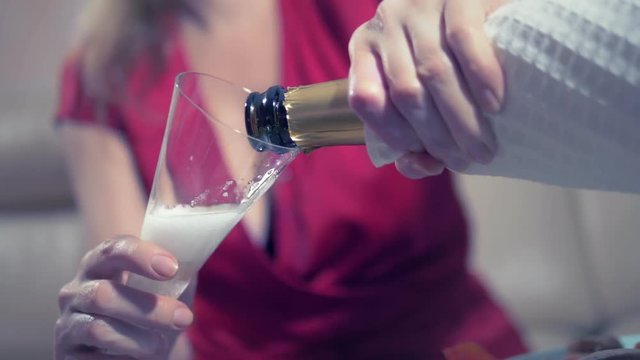 woman gets drunk at home alone at a table set for two for a romantic date, as her partner did not come on a date