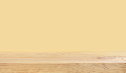 Empty of wood table top on yellow pastel color background