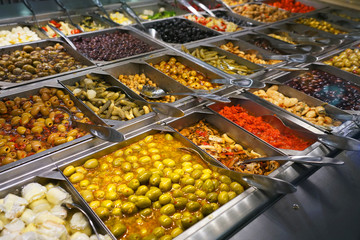 variety of colorful fresh vegetable salad in container in restaurant