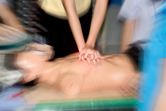 Education healthcare first aid of CPR training medical procedure, demonstrating chest compression on CPR doll ,emergency training for safe life use automated external defibrillator(AED). Zoom effect.