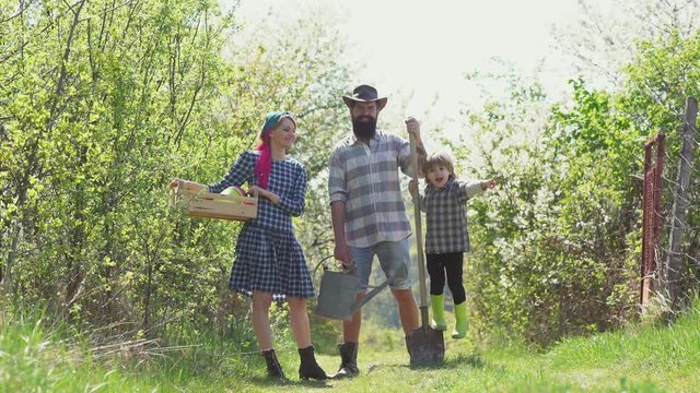 Family farmer concept. Happy family. Happy family farmers working with spud on spring field. Eco Resort Activities. Retro family farmers.