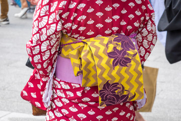 Young girl wearing Japanese kimono standing in front of Sensoji Temple in Tokyo, Japan. Kimono is a Japanese traditional garment. The word 