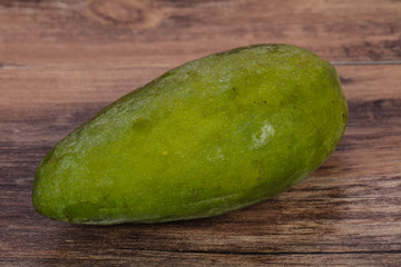 Green tasty mango over wooden background