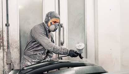 A man painting a car