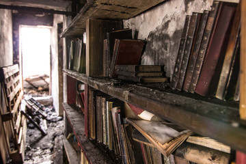 Fototapeta na wymiar Book burnt in a bookcase after a fire.Disaster, Ignorance, Brain Washing, Desolation.