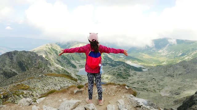 Little girl feeling happy at the highest Musala Peak in Rilla National Park, Bulgaria