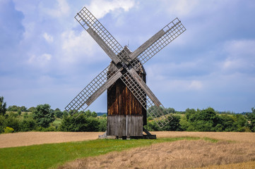 Fototapeta na wymiar 18th century post mill on a field in Poland