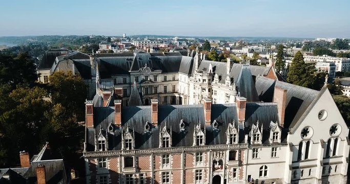 BLOIS, FRANCE - OCTOBER 09, 2018: View from drone of impressive Royal Chateau de Blois on background with cityscape in sunny autumn day, France