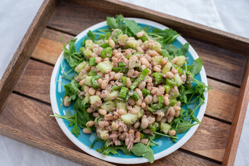 Salad with spinach, arugula, avocado, sprouted seeds and beans