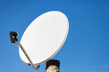Satellite dish antenna on blue sky