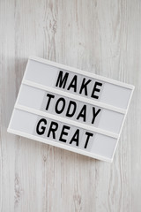 Lightbox with 'Make today great' words on a white wooden surface, top view. Overhead, from above. Flat lay.