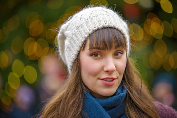 Happy woman smiling and Christmas tree behind