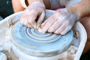 Making pottery on a potter's wheel. Hands craftsman close-up, mold dishes. Master class