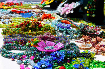 Selling beautiful colorful women's jewelry from beads. Fair - an exhibition of folk craftsmen.