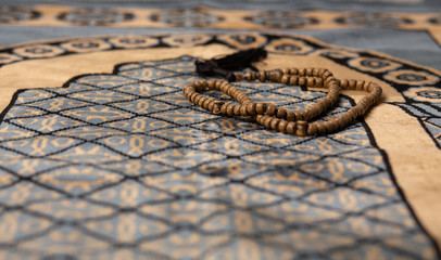 muslim concep-tasbih White wood beads placed on carpet in mosque muslim praye Islamic beliefs,Concept: Culture beliefs for mercy from heaven