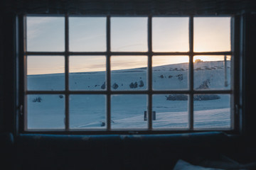 Winter landscape thru a cabin window on Svalbard. 