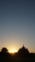 the beginning of summer when the sun rises with the foreground of a temple that looks very beautiful