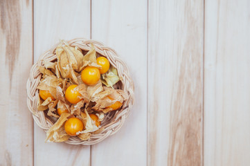 Physalis , golden gooseberry on wooden background, flat lay,  space for text