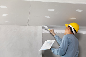 Craftsman working with plaster gypsum ceiling for interior build gypsum board ceiling - obrazy, fototapety, plakaty