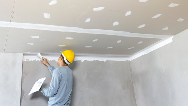 Craftsman working with plaster gypsum ceiling for interior build gypsum board ceiling