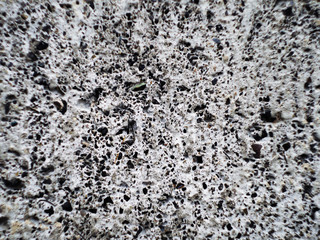 Grey wall made of marble aggregate with small crumbs, close up view. Abstract background. Marble aggregate texture close up. Marble wall pattern
