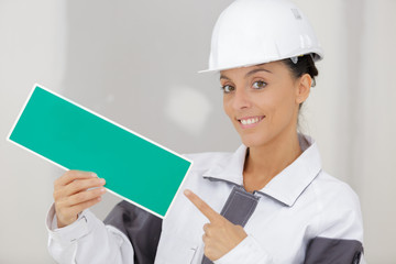 woman painter holding wet paint sign