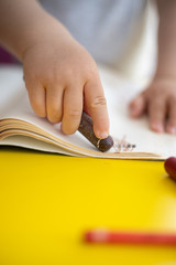 close up of hands of baby toddler drawing. copy space