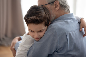Grandfather and little child hug showing love and support