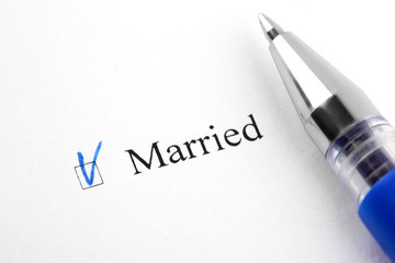 Fototapeta premium Married. Filling in the questionnaire, documents. The checkboxes are filled with a black pen on a white background. Questionnaire, survey.