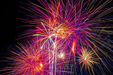 Obraz premium background of multi-colored salute and fireworks closeup on a black background
