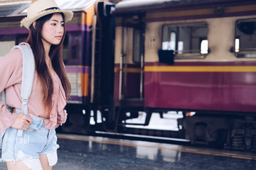 woman  backpacker traveler with backpack at train station. journey trip travel concept