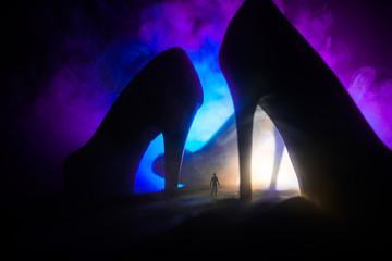 Artwork decoration. Silhouette of a man standing in the middle of the road on a misty night with...