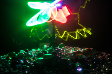 Music concept. Acoustic guitar isolated on a dark background under beam of light with smoke with copy space. Guitar Strings, close up. Selective focus. Fire effects. Surreal guitar