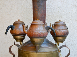 old teapots and Turkish tea on wall background