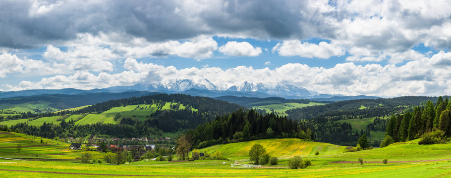 Panoramic view over Tatra mountains range and traditional pasture meadows in Pieniny Park