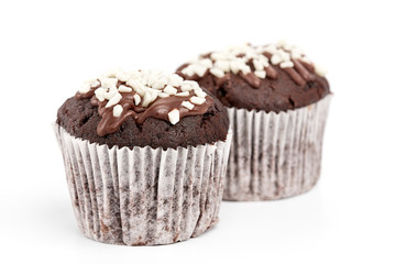 Tasty chocolate cupcakes on white background. Chocolate caramel cupcake and butterscotch syrup. Chocolate cupcake isolated on white.