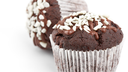 Tasty chocolate cupcakes on white background. Chocolate caramel cupcake and butterscotch syrup. Chocolate cupcake isolated on white.