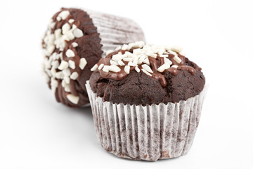 Tasty chocolate cupcakes on white background. Chocolate caramel cupcake and butterscotch syrup. Chocolate cupcake isolated on white.