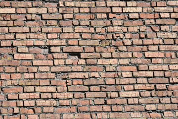 crumbling old red brick wall