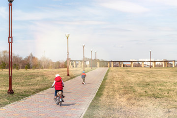 Children boy and girl riding bicycles in the Park