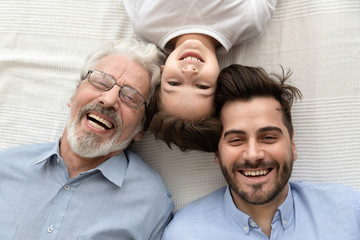 Top view of happy three generations of men smiling