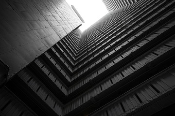 Abstract building facade concrete void or tunnel with natural light in the end in twist view/...