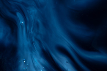 dark abstract texture. blue paint. paint ink stains in water