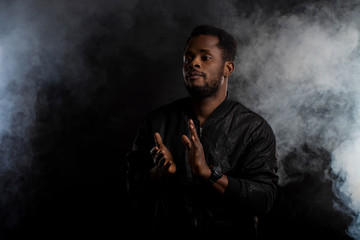 Young handsome african american man dancing in dark